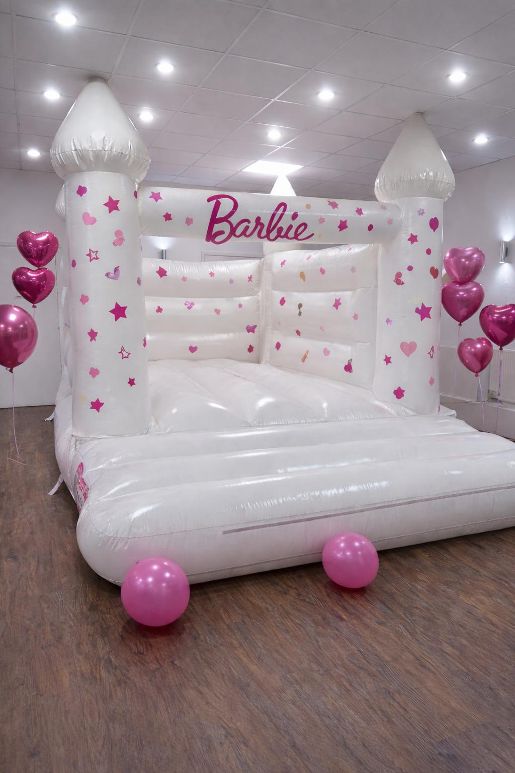 White Barbie themed bouncy castle with pink heart balloons